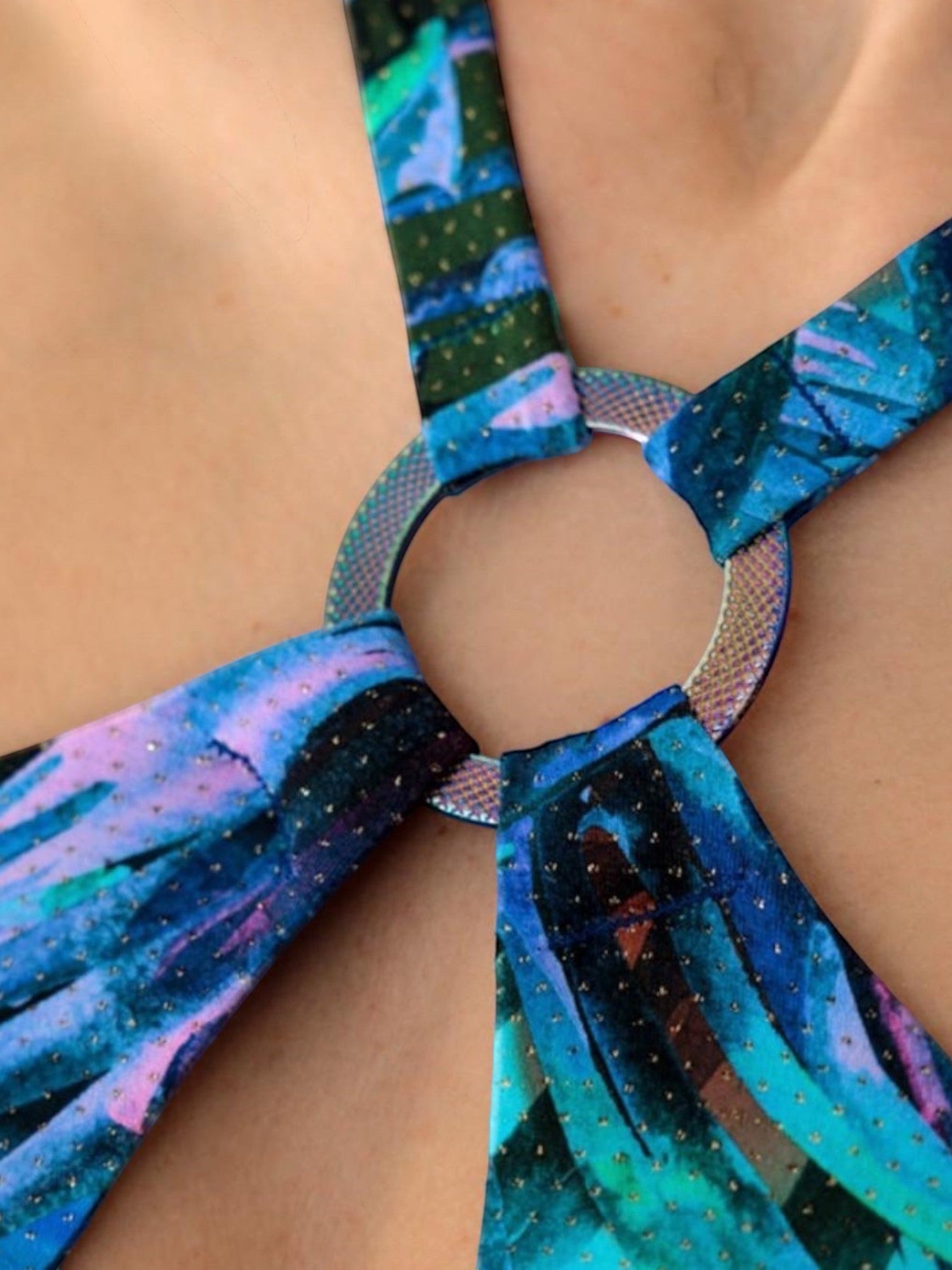 LIA STUDIO LINGERIE Adelina: a blue one-piece swimsuit featuring a "night jungle" print, adorned with a round, shimmering detail, and tied at the neck and back.